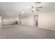 Spacious living room with ceiling fans and neutral carpet at 19061 N Toya St, Maricopa, AZ 85138