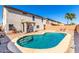 Backyard oasis featuring a sparkling pool, gravel landscaping and patio seating at 19061 N Toya St, Maricopa, AZ 85138