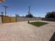Low maintenance backyard featuring gravel, block wall, artificial turf, and new wood gate at 1909 N 74Th St, Scottsdale, AZ 85257