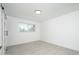 Cozy bedroom with gray tile floors, large sliding door closet, and natural light at 1909 N 74Th St, Scottsdale, AZ 85257