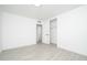 Bright bedroom with neutral paint, light wood-look flooring, and a double closet at 1909 N 74Th St, Scottsdale, AZ 85257