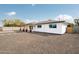 Side angle view of a charming single-story home featuring a covered front entry and desert landscaping at 1909 N 74Th St, Scottsdale, AZ 85257