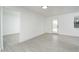 Clean living space showing white walls, light colored tile floors, and a back door at 1909 N 74Th St, Scottsdale, AZ 85257