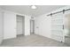 Bright primary bedroom with barn door to shower and closet with sliding doors at 1909 N 74Th St, Scottsdale, AZ 85257