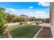 Backyard area featuring artificial turf, landscaping, and a hot tub at 19232 W Madison St, Buckeye, AZ 85326