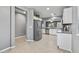 Stainless steel refrigerator in the kitchen with view of living room at 19232 W Madison St, Buckeye, AZ 85326