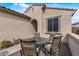 Cozy outdoor patio featuring a seating area with a table and four chairs at 19232 W Madison St, Buckeye, AZ 85326