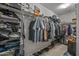 Organized walk-in closet featuring shelving, hanging rods, and ample storage space for clothes and accessories at 19232 W Madison St, Buckeye, AZ 85326