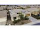 An aerial view of a home with solar panels in a well-developed suburban neighborhood at 19746 N Heron Ct, Maricopa, AZ 85138