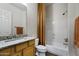 A well-lit bathroom features a granite-topped vanity and a shower-tub combo with a stylish curtain at 19746 N Heron Ct, Maricopa, AZ 85138