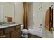 Cozy bathroom with decorative tile, a shower-tub combination, and updated fixtures at 19746 N Heron Ct, Maricopa, AZ 85138