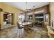 A bright dining room featuring tile floors, large windows, and a ceiling fan at 19746 N Heron Ct, Maricopa, AZ 85138