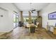 Bright dining room with tile floors, ceiling fan and access to outdoor pool at 19746 N Heron Ct, Maricopa, AZ 85138