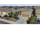 Inviting single-story home with desert landscaping, a two-car garage, and solar panels at 19746 N Heron Ct, Maricopa, AZ 85138