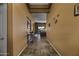 Long hallway features tile flooring and a view into the living area at 19746 N Heron Ct, Maricopa, AZ 85138