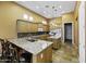 An expansive kitchen showcases granite counters, a center island, and modern appliances at 19746 N Heron Ct, Maricopa, AZ 85138