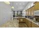 Gourmet kitchen with granite countertops, island, and stainless steel appliances at 19746 N Heron Ct, Maricopa, AZ 85138
