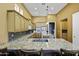 A gourmet kitchen equipped with granite counters, modern appliances, and wooden cabinetry at 19746 N Heron Ct, Maricopa, AZ 85138