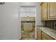 View of a gourmet kitchen with custom cabinetry and an expansive granite island at 19746 N Heron Ct, Maricopa, AZ 85138