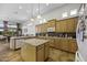Spacious kitchen featuring custom cabinetry, tile backsplash, and modern appliances at 19746 N Heron Ct, Maricopa, AZ 85138