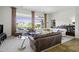 Bright living room with large windows, high ceilings, and neutral-toned furniture at 19746 N Heron Ct, Maricopa, AZ 85138