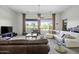 Inviting living area with comfortable sofas, television and natural light at 19746 N Heron Ct, Maricopa, AZ 85138