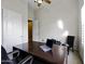 A functional home office space includes a large desk with a laptop, a chair, and ample lighting at 19746 N Heron Ct, Maricopa, AZ 85138