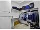 Walk-in closet with ample storage space and organized hanging racks at 19746 N Heron Ct, Maricopa, AZ 85138