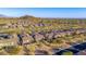 Scenic aerial shot of community homes, mountains, and desert landscaping at 2124 N 89Th Pl, Mesa, AZ 85207