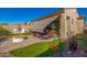 Spacious backyard featuring a covered patio, built-in grill, fire pit, and low maintenance artificial turf at 2124 N 89Th Pl, Mesa, AZ 85207