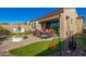 Large backyard featuring a covered patio, built-in outdoor kitchen, fire pit, and artificial turf lawn at 2124 N 89Th Pl, Mesa, AZ 85207