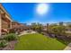 Inviting backyard with a fire pit, artificial grass, and desert landscaping perfect for outdoor living at 2124 N 89Th Pl, Mesa, AZ 85207
