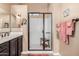 Bathroom with vanity sink, framed mirror and glass shower with bench at 2124 N 89Th Pl, Mesa, AZ 85207