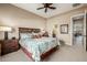 Bedroom with a floral pattern bedspread and ensuite bathroom access at 2124 N 89Th Pl, Mesa, AZ 85207