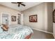 Bedroom featuring a floral patterned comforter with ensuite bathroom entrances at 2124 N 89Th Pl, Mesa, AZ 85207