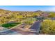 Scenic view of the Bella Via entrance showcasing landscaping and a gated entry at 2124 N 89Th Pl, Mesa, AZ 85207