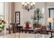 Bright dining area with a wooden table, seating for six, and a view into the living room at 2124 N 89Th Pl, Mesa, AZ 85207