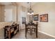 Cozy dining area features a small table with seating for two and a decorative buffet at 2124 N 89Th Pl, Mesa, AZ 85207