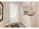 Bright and open entryway featuring a decorative rug, white door, and peek-a-boo view of the dining area at 2124 N 89Th Pl, Mesa, AZ 85207
