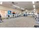 Spacious gym features various fitness equipment, ample lighting, mirrored wall, and neutral carpet at 2124 N 89Th Pl, Mesa, AZ 85207