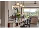 Kitchen island offering seating and views of the dining area and living room, great for entertaining at 2124 N 89Th Pl, Mesa, AZ 85207