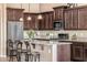 Well-lit kitchen features a large island with barstool seating, stainless steel appliances, and abundant cabinetry at 2124 N 89Th Pl, Mesa, AZ 85207