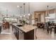 Open-concept kitchen with an island that overlooks the dining and living areas, offering a seamless flow at 2124 N 89Th Pl, Mesa, AZ 85207