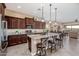 Spacious kitchen featuring granite countertops, a large island with seating, and stainless steel appliances at 2124 N 89Th Pl, Mesa, AZ 85207