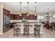 Bright and spacious kitchen featuring an island with seating, stainless steel appliances, and warm neutral tones at 2124 N 89Th Pl, Mesa, AZ 85207