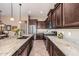 Kitchen showcasing granite counters, stainless steel appliances and dark wood cabinetry at 2124 N 89Th Pl, Mesa, AZ 85207
