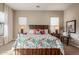 Bright main bedroom featuring a rustic wood bed frame, windows and neutral carpet at 2124 N 89Th Pl, Mesa, AZ 85207