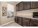 Office with built in cabinets, counter space and natural light at 2124 N 89Th Pl, Mesa, AZ 85207