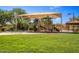 Community playground featuring covered play area, picnic tables and seating for residents at 2124 N 89Th Pl, Mesa, AZ 85207