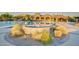 Upscale community pool area with water fountain, landscaping and covered seating for residents at 2124 N 89Th Pl, Mesa, AZ 85207